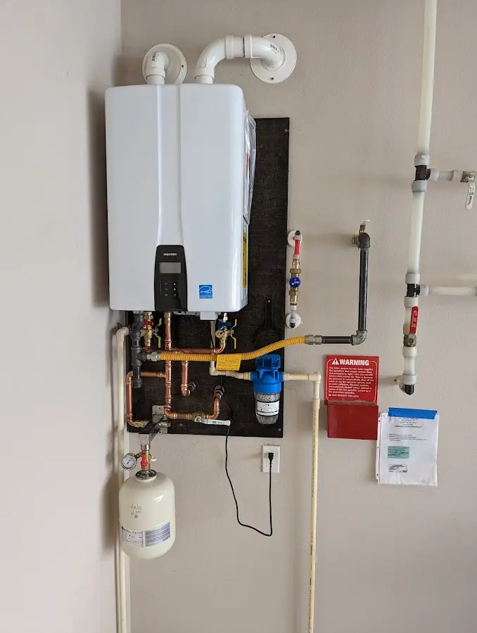 Professional plumber installing copper piping in a Raymond home